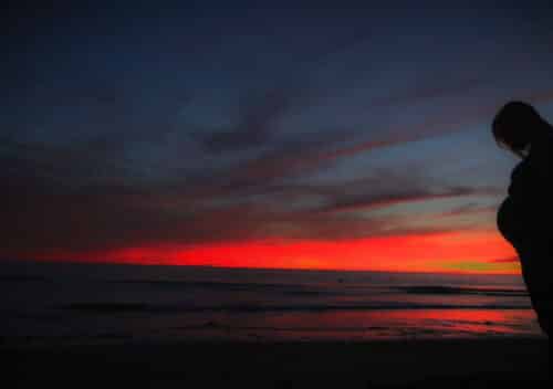 Expecting Mom in front of Sunset on Beach